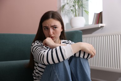 Photo of Worried woman suffering from paranoia at home