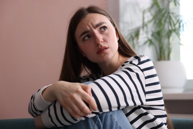 Photo of Scared woman suffering from paranoia at home