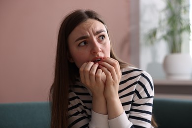 Photo of Scared woman suffering from paranoia at home