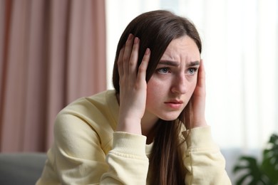 Photo of Scared woman suffering from paranoia at home