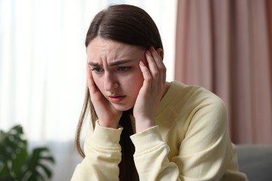 Photo of Scared woman suffering from paranoia at home