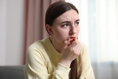 Photo of Scared woman suffering from paranoia at home