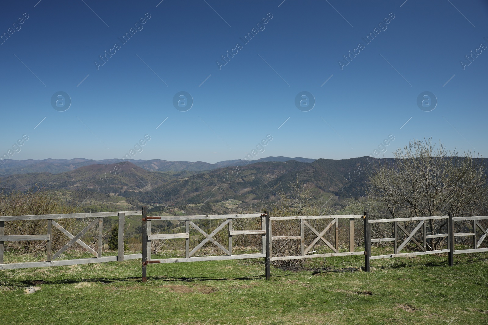 Picturesque view of wooden fence near mountains and forest Photo of Picturesque view of wooden fence near mountains and forest