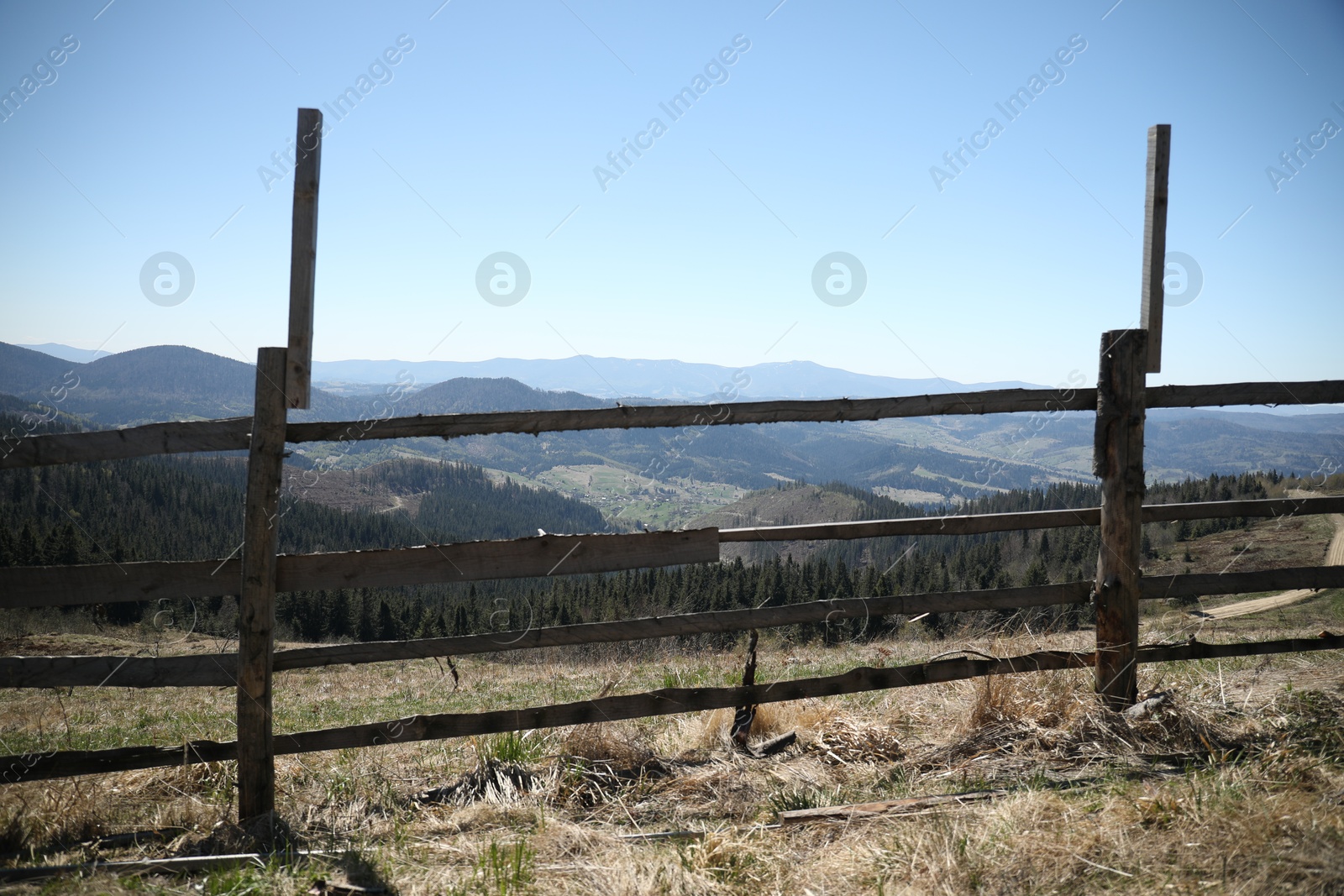 Picturesque view of wooden fence near mountains and forest Photo of Picturesque view of wooden fence near mountains and forest