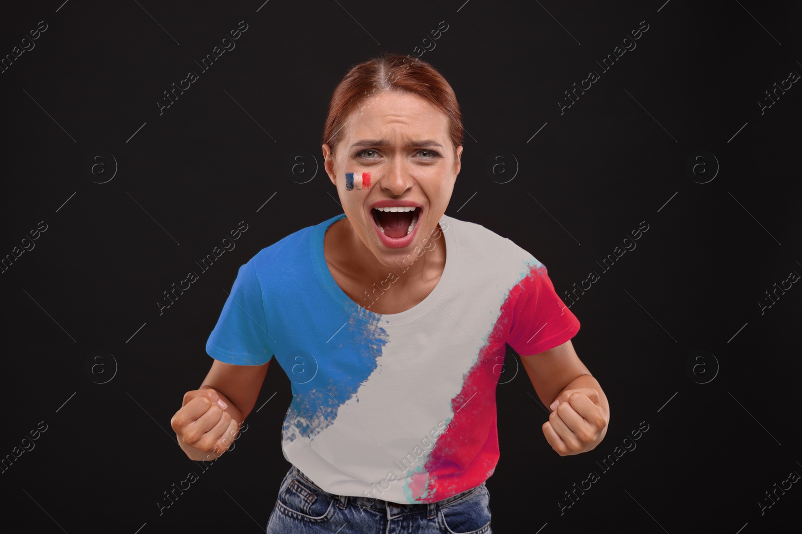 Excited fan with flags of France on her cheek and t-shirt against black background Image of Excited fan with flags of France on her cheek and t-shirt against black background