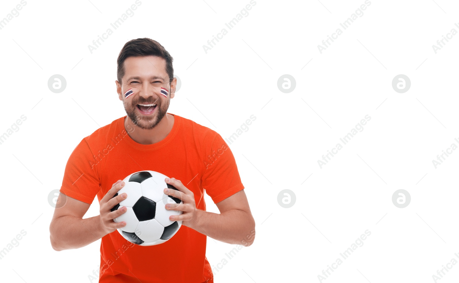 Excited fan with flags of Thailand painted on his face holding soccer ball against white background. Banner design with space for text Image of Excited fan with flags of Thailand painted on his face holding soccer ball against white background. Banner design with space for text