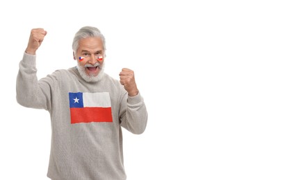 Image of Excited fan with flags of Chile on his face and sweater against white background. Banner design with space for text
