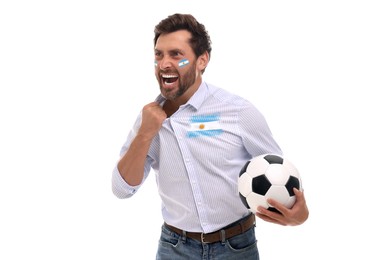 Image of Excited fan with flags of Argentina on his face and shirt holding soccer ball against white background
