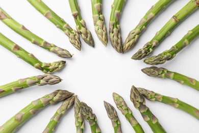 Photo of Frame of raw asparagus on white background, flat lay. Space for text