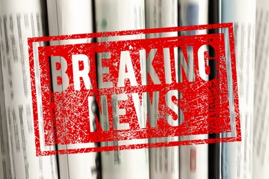 Image of Red Breaking News stamp and newspapers as background, closeup