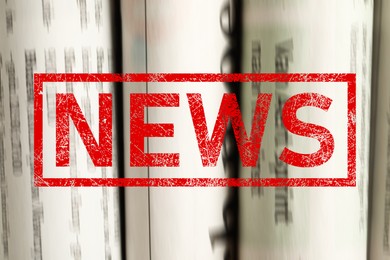 Image of Red News stamp and newspapers as background, closeup