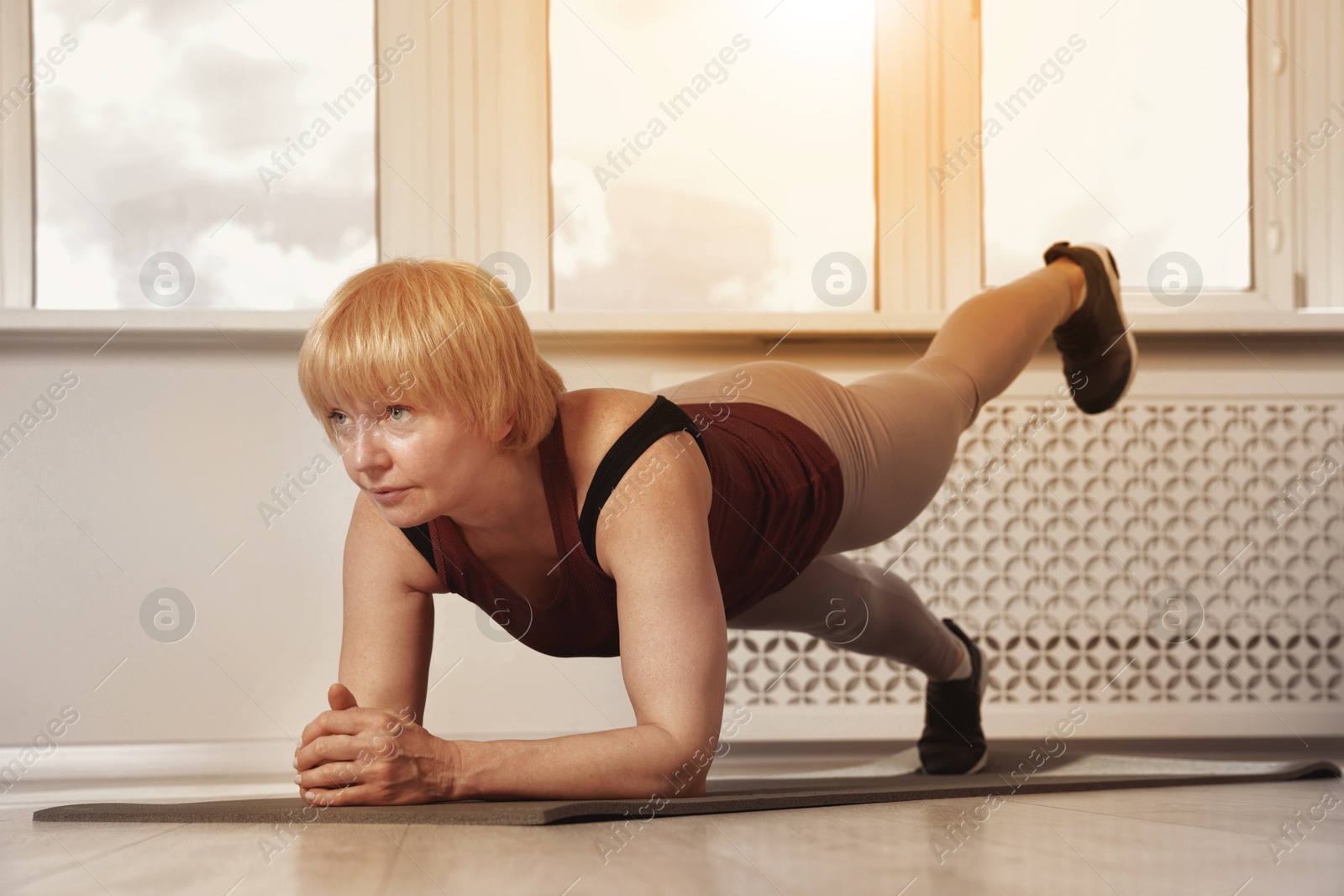Woman doing plank exercise on fitness mat indoors. Sport and healthy lifestyle Image of Woman doing plank exercise on fitness mat indoors. Sport and healthy lifestyle