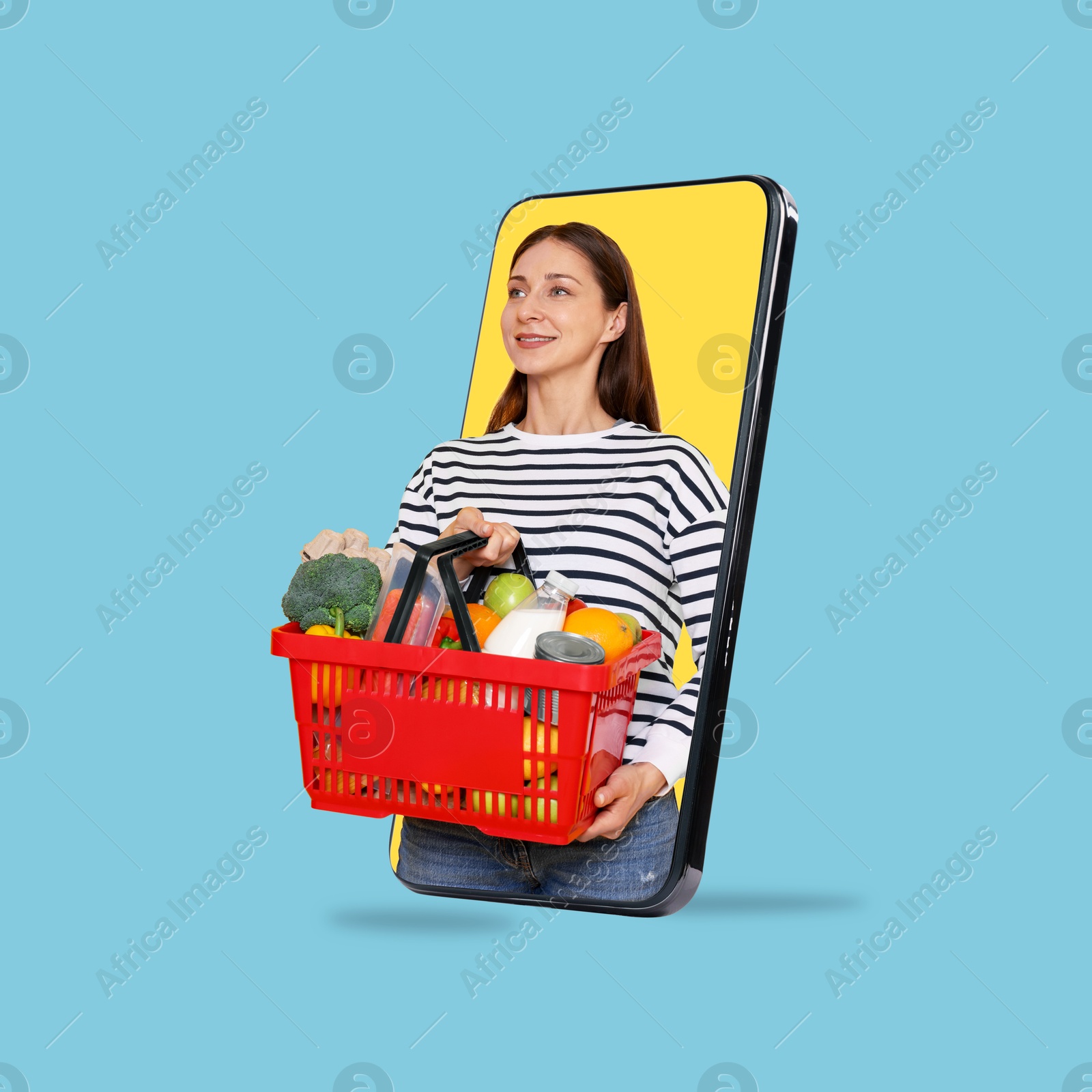 Woman with shopping basket full of products walking out of mobile phone against light blue background. Online ordering Image of Woman with shopping basket full of products walking out of mobile phone against light blue background. Online ordering