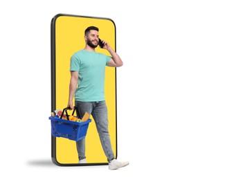 Image of Man with shopping basket full of products walking out of mobile phone against white background. Online ordering