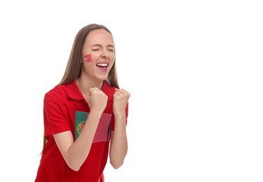 Image of Excited fan with flags of Portugal on her cheek and t-shirt against white background. Space for text