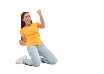 Image of Excited fan with flags of Spain painted on her body against white background. Celebrating victory