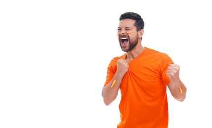 Image of Excited fan with colors matching Spain flag painted on his face and arms against white background. Banner design with space for text