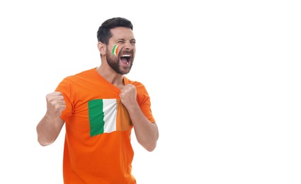 Image of Excited fan with flags of Ireland on his face and t-shirt against white background. Banner design with space for text