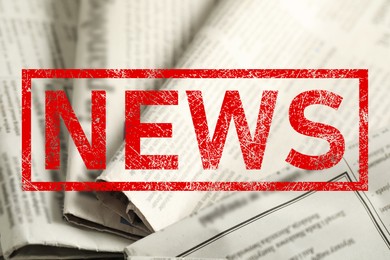 Image of Red News stamp and newspapers as background, closeup