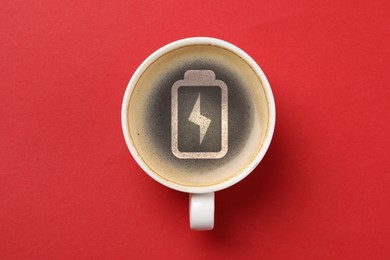 Image of Cup of coffee with battery indicator on red background, top view. Restoring energy with caffeine