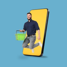 Image of Man with shopping basket jumping out of mobile phone against light blue background. Online ordering
