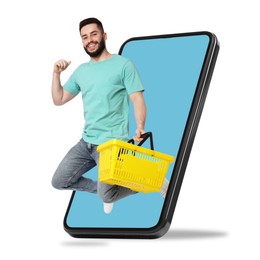 Image of Man with shopping basket jumping out of mobile phone against white background. Online ordering