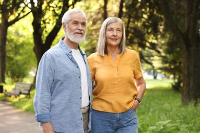Photo of Lovely senior couple walking together in park