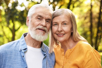 Photo of Lovely senior couple walking together in park