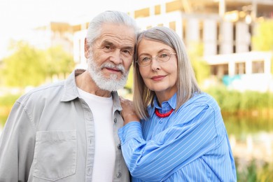 Photo of Lovely senior couple walking together in park