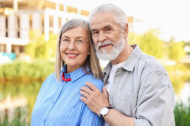 Photo of Lovely senior couple walking together in park