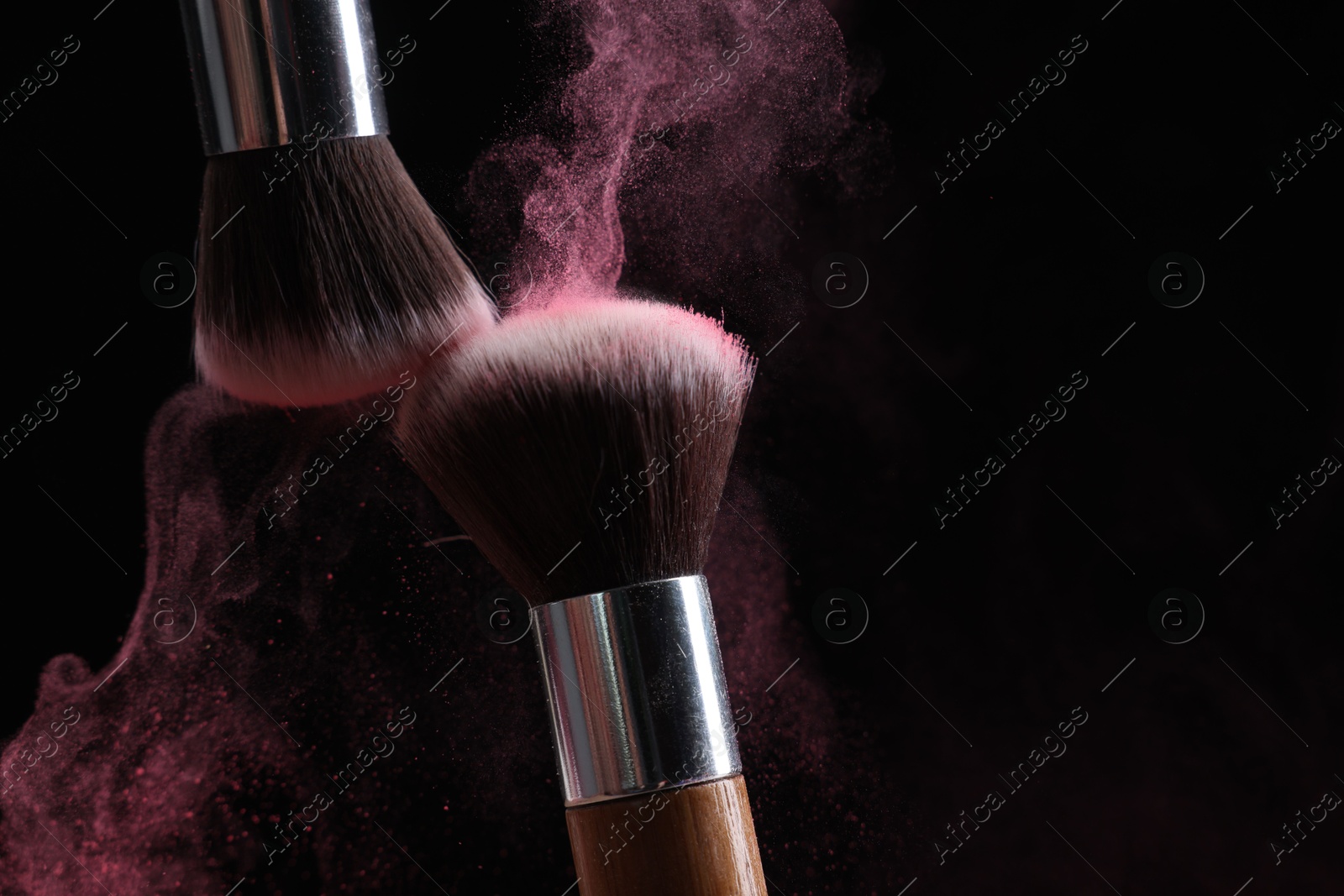 Makeup brushes with color eye shadow on black background, closeup Photo of Makeup brushes with color eye shadow on black background, closeup