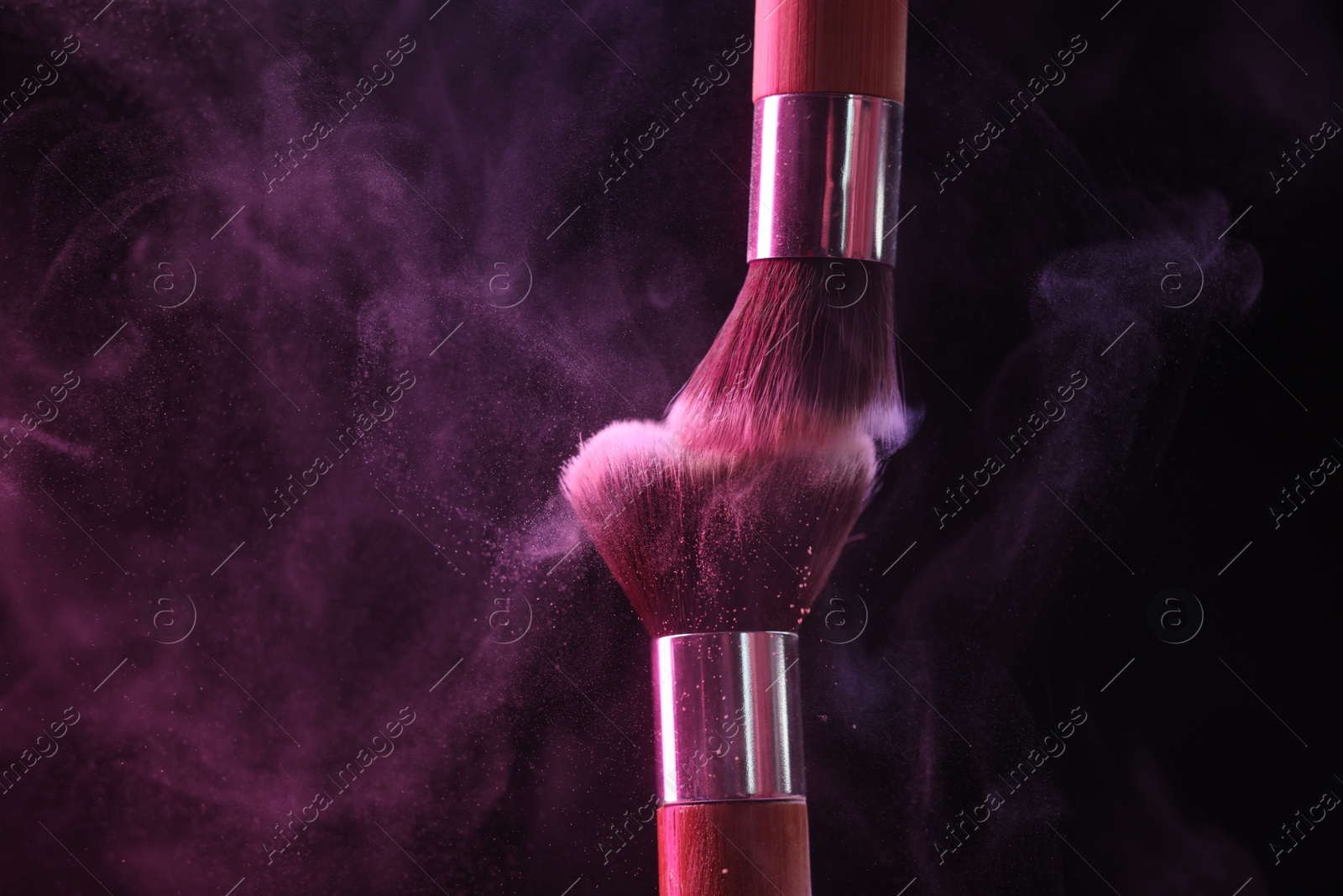 Makeup brushes with colorful eye shadows on black background, closeup Photo of Makeup brushes with colorful eye shadows on black background, closeup