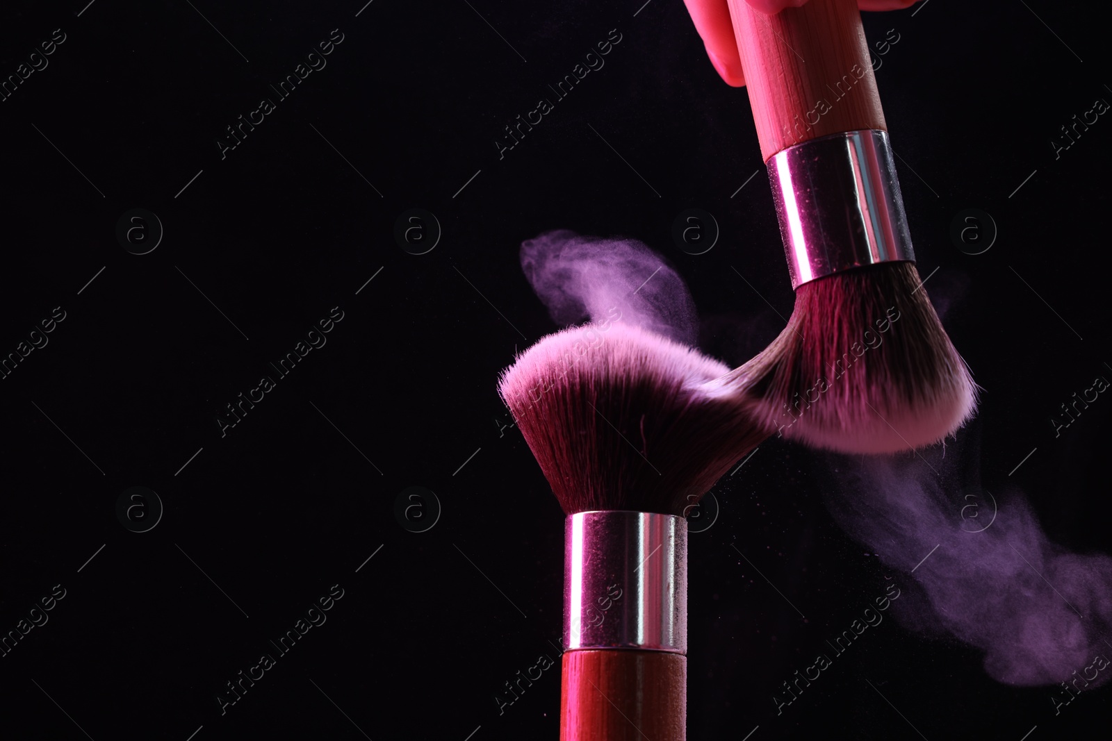 Makeup brushes with color eye shadow on black background, closeup. Space for text Photo of Makeup brushes with color eye shadow on black background, closeup. Space for text