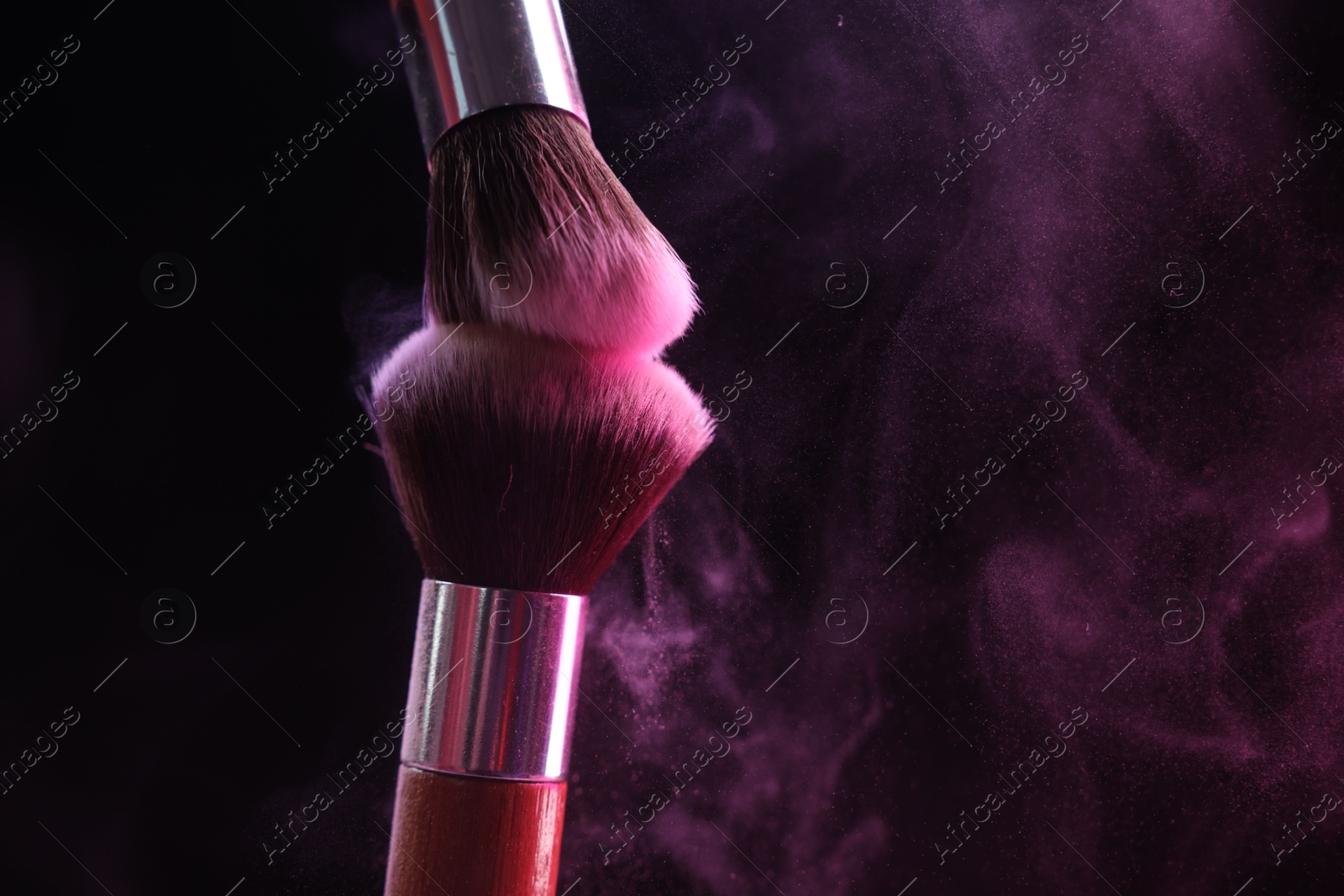 Makeup brushes with color eye shadow on black background, closeup. Space for text Photo of Makeup brushes with color eye shadow on black background, closeup. Space for text