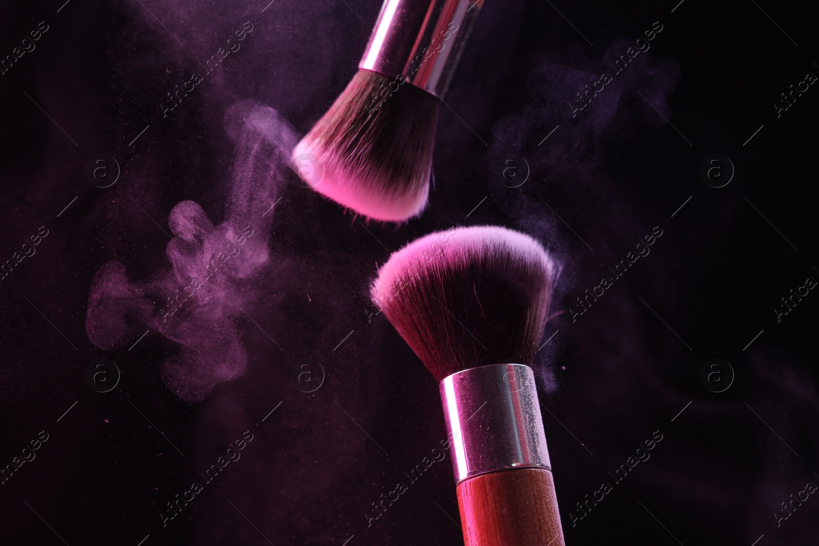 Makeup brushes with color eye shadow on black background, closeup Photo of Makeup brushes with color eye shadow on black background, closeup