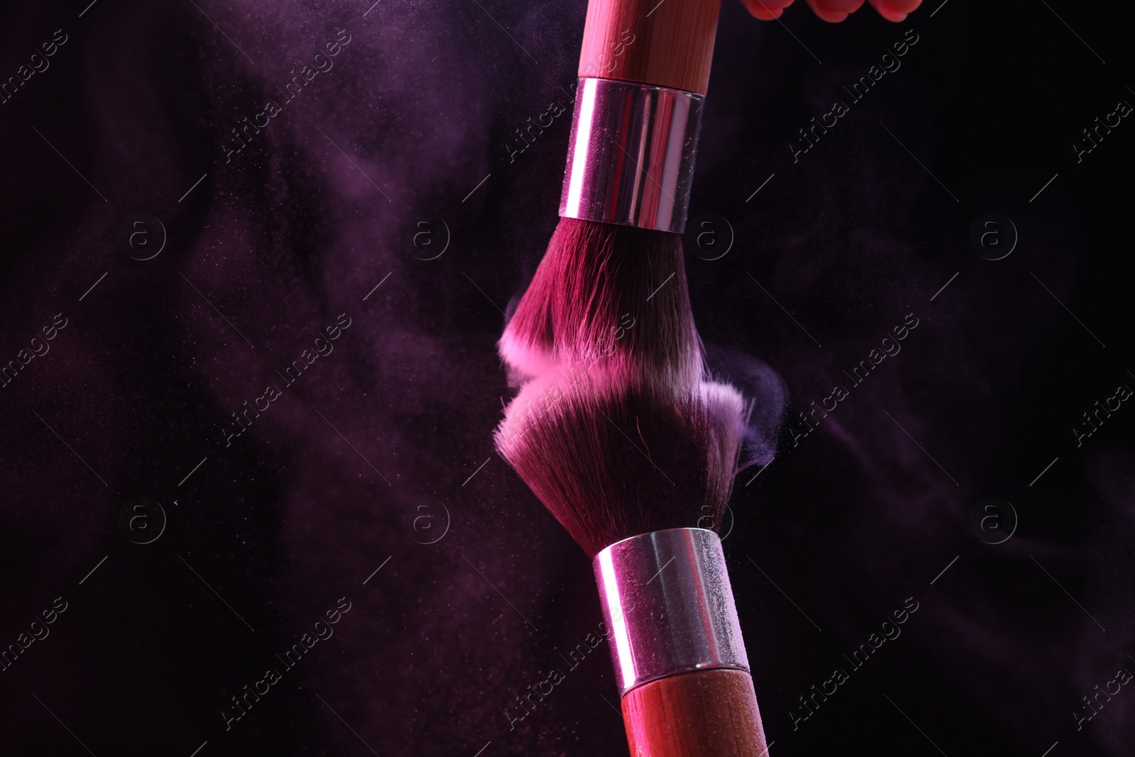 Makeup brushes with color eye shadow on black background, closeup Photo of Makeup brushes with color eye shadow on black background, closeup