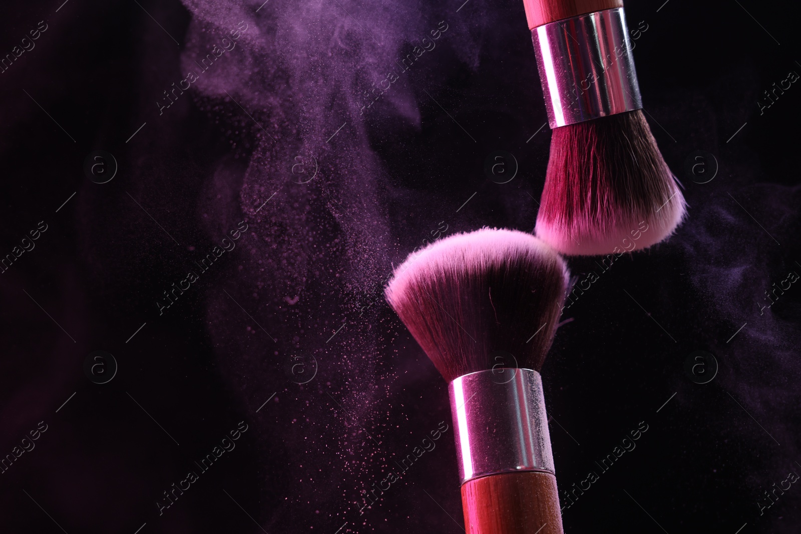 Makeup brushes with color eye shadow on black background, closeup. Space for text Photo of Makeup brushes with color eye shadow on black background, closeup. Space for text