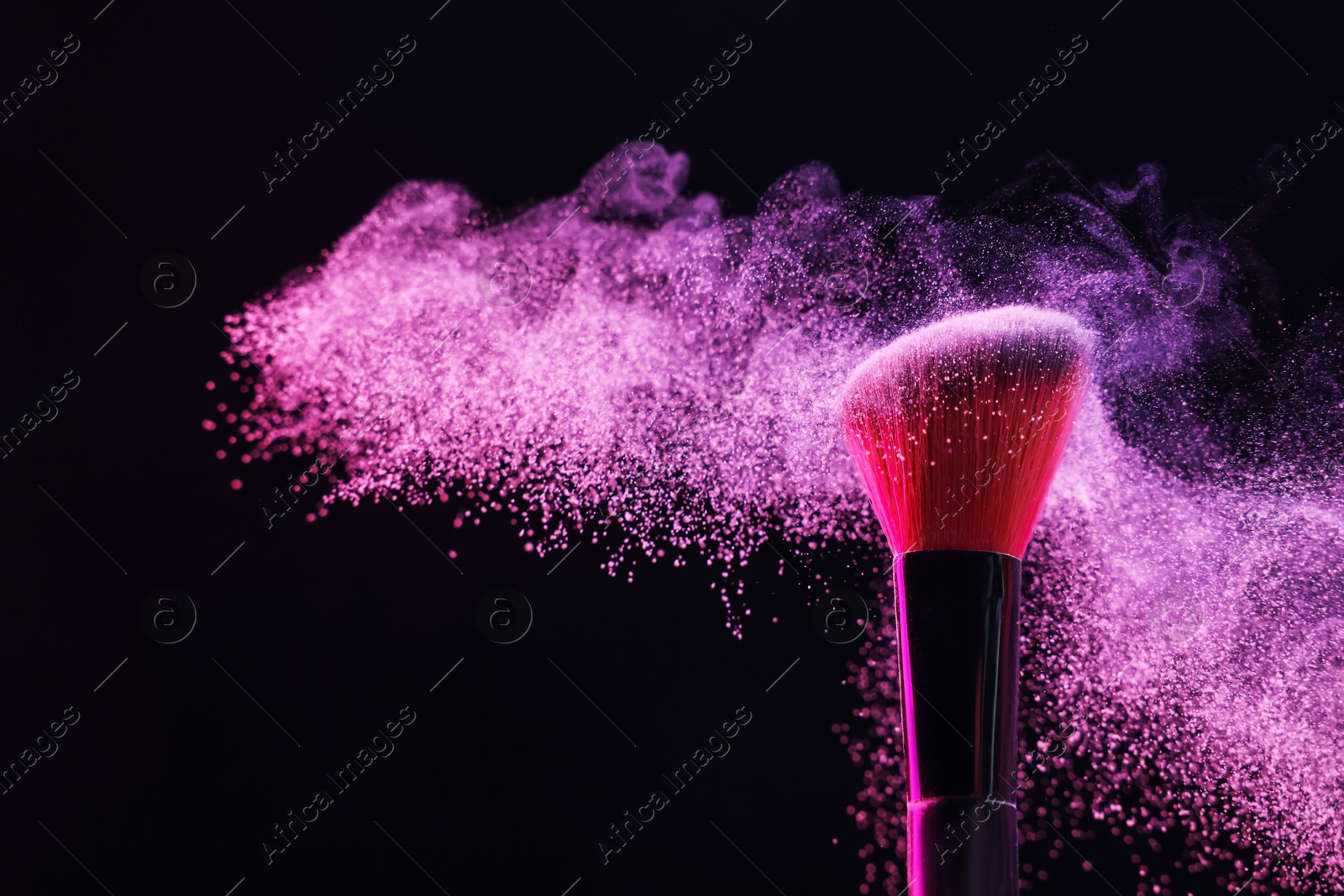 Makeup brush with pink eye shadow on black background, closeup Photo of Makeup brush with pink eye shadow on black background, closeup