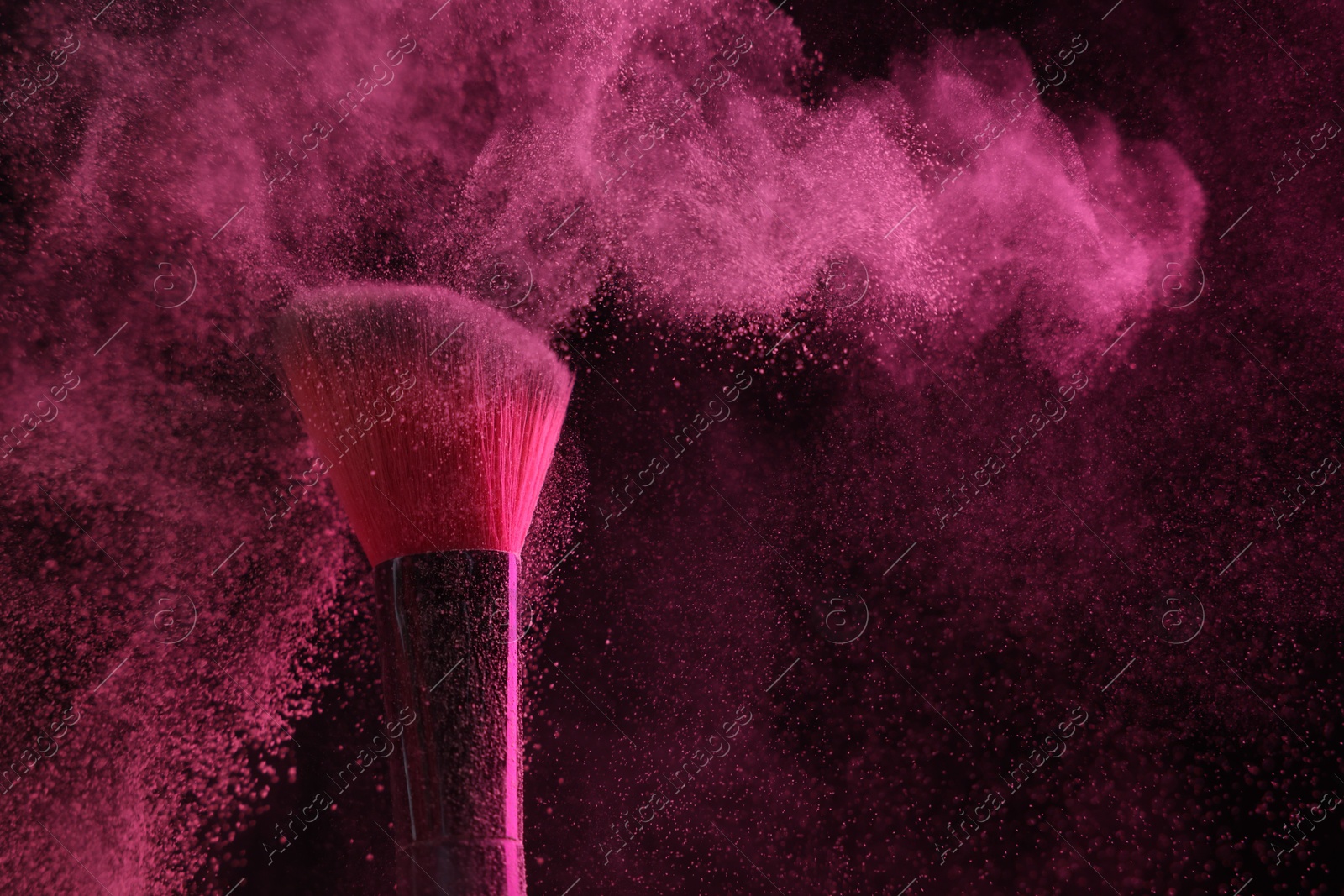 Makeup brush with pink eye shadow on black background, closeup Photo of Makeup brush with pink eye shadow on black background, closeup