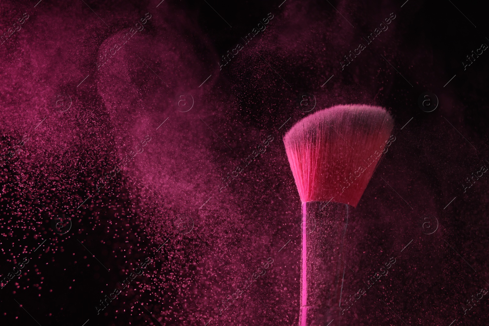 Makeup brush with pink eye shadow on black background, closeup Photo of Makeup brush with pink eye shadow on black background, closeup