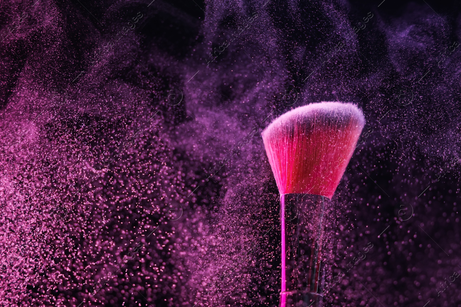 Makeup brush with pink eye shadow on black background, closeup Photo of Makeup brush with pink eye shadow on black background, closeup