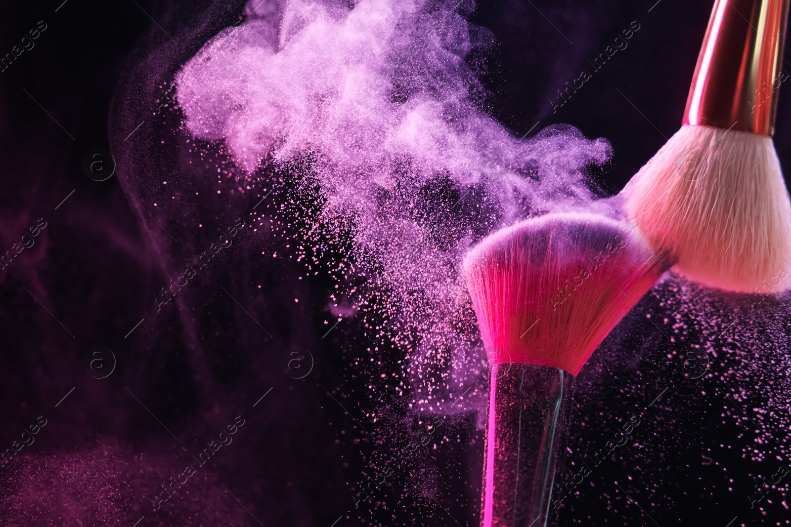 Makeup brushes with color eye shadow in neon lights on black background, closeup. Space for text Photo of Makeup brushes with color eye shadow in neon lights on black background, closeup. Space for text