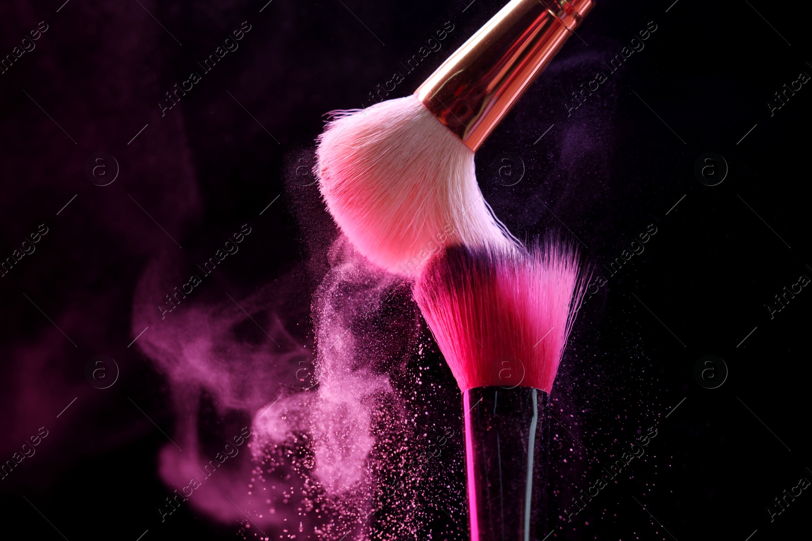 Makeup brushes with pink eye shadow on black background, closeup. Space for text Photo of Makeup brushes with pink eye shadow on black background, closeup. Space for text