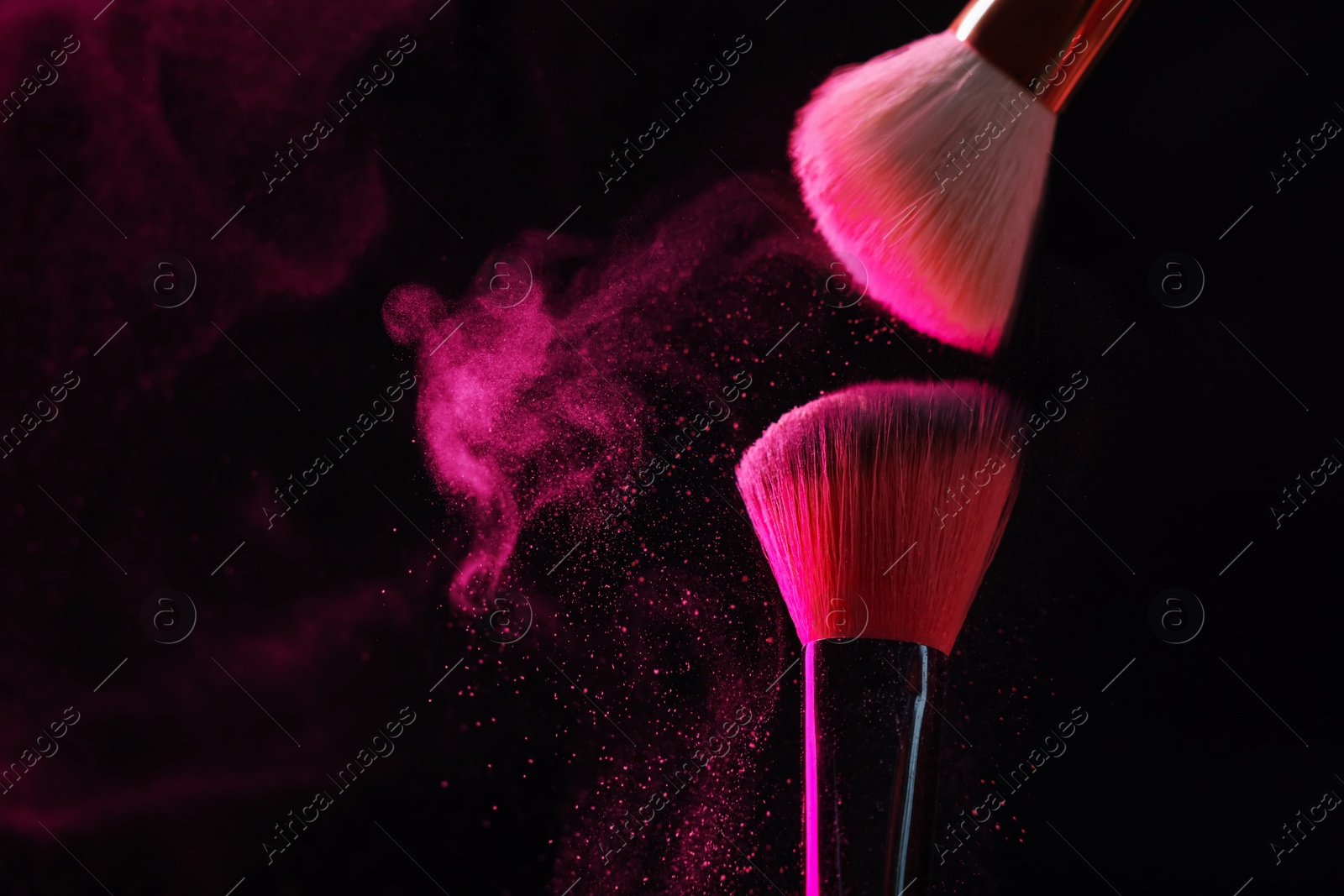 Makeup brushes with pink eye shadow on black background, closeup. Space for text Photo of Makeup brushes with pink eye shadow on black background, closeup. Space for text