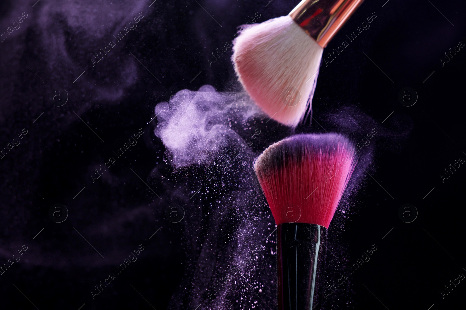 Makeup brushes with purple eye shadow on black background, closeup. Space for text Photo of Makeup brushes with purple eye shadow on black background, closeup. Space for text