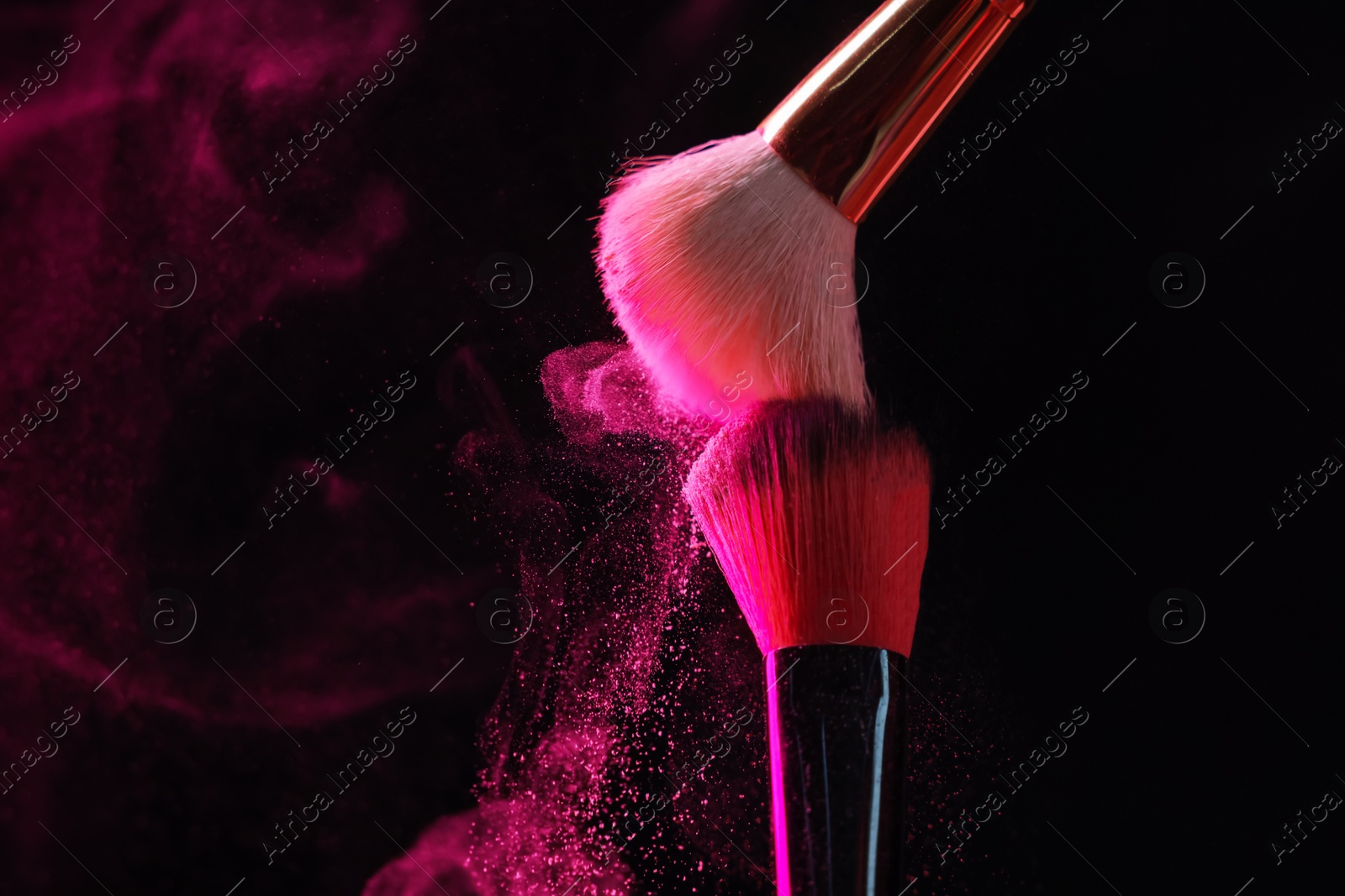 Makeup brushes with pink eye shadow on black background, closeup. Space for text Photo of Makeup brushes with pink eye shadow on black background, closeup. Space for text