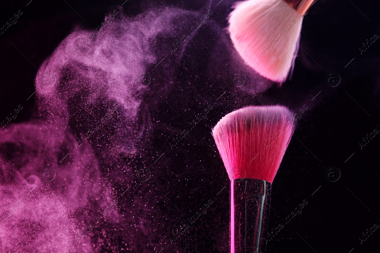 Makeup brushes with pink eye shadow on black background, closeup. Space for text Photo of Makeup brushes with pink eye shadow on black background, closeup. Space for text