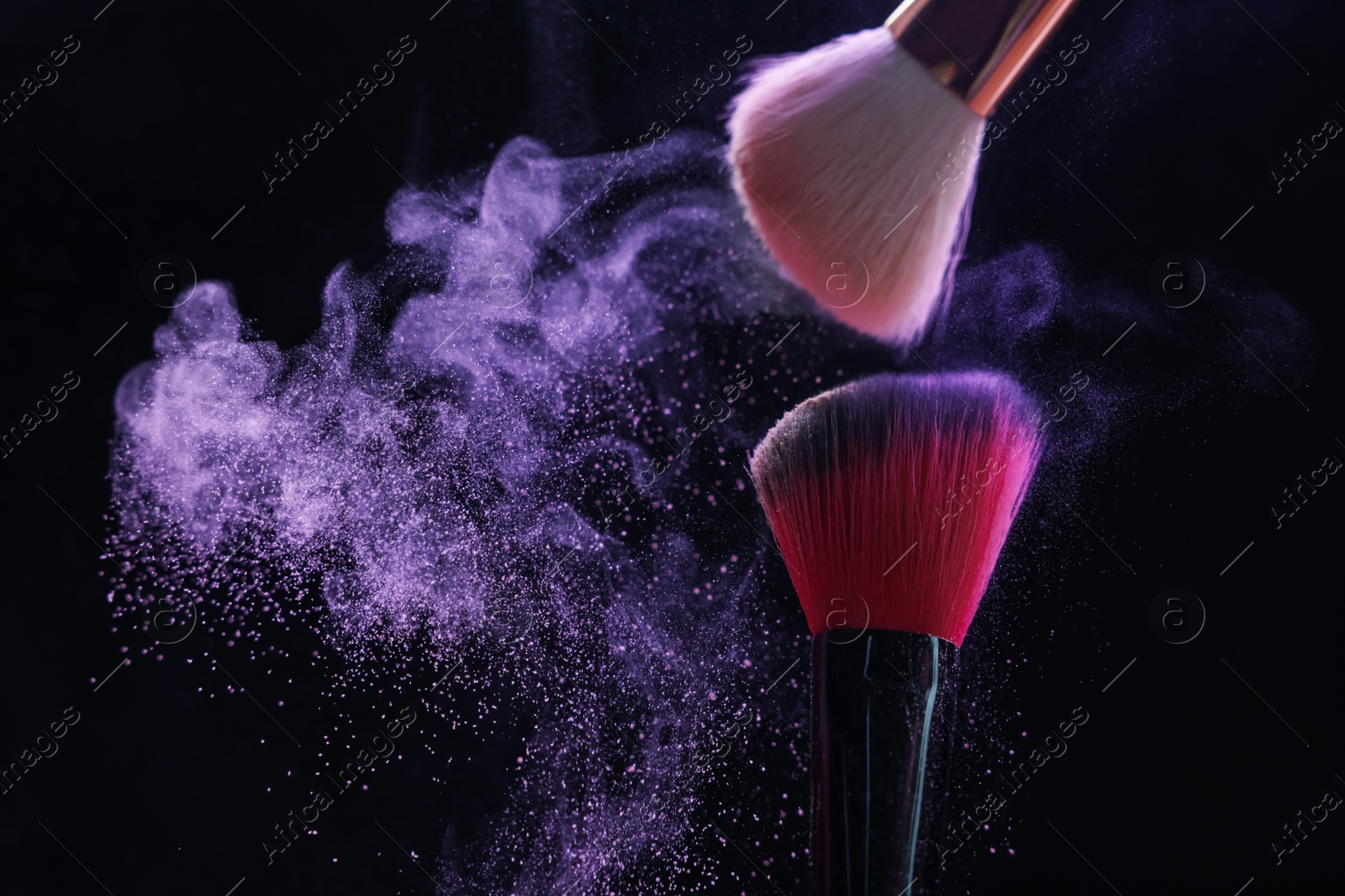 Makeup brushes with purple eye shadow on black background, closeup. Space for text Photo of Makeup brushes with purple eye shadow on black background, closeup. Space for text