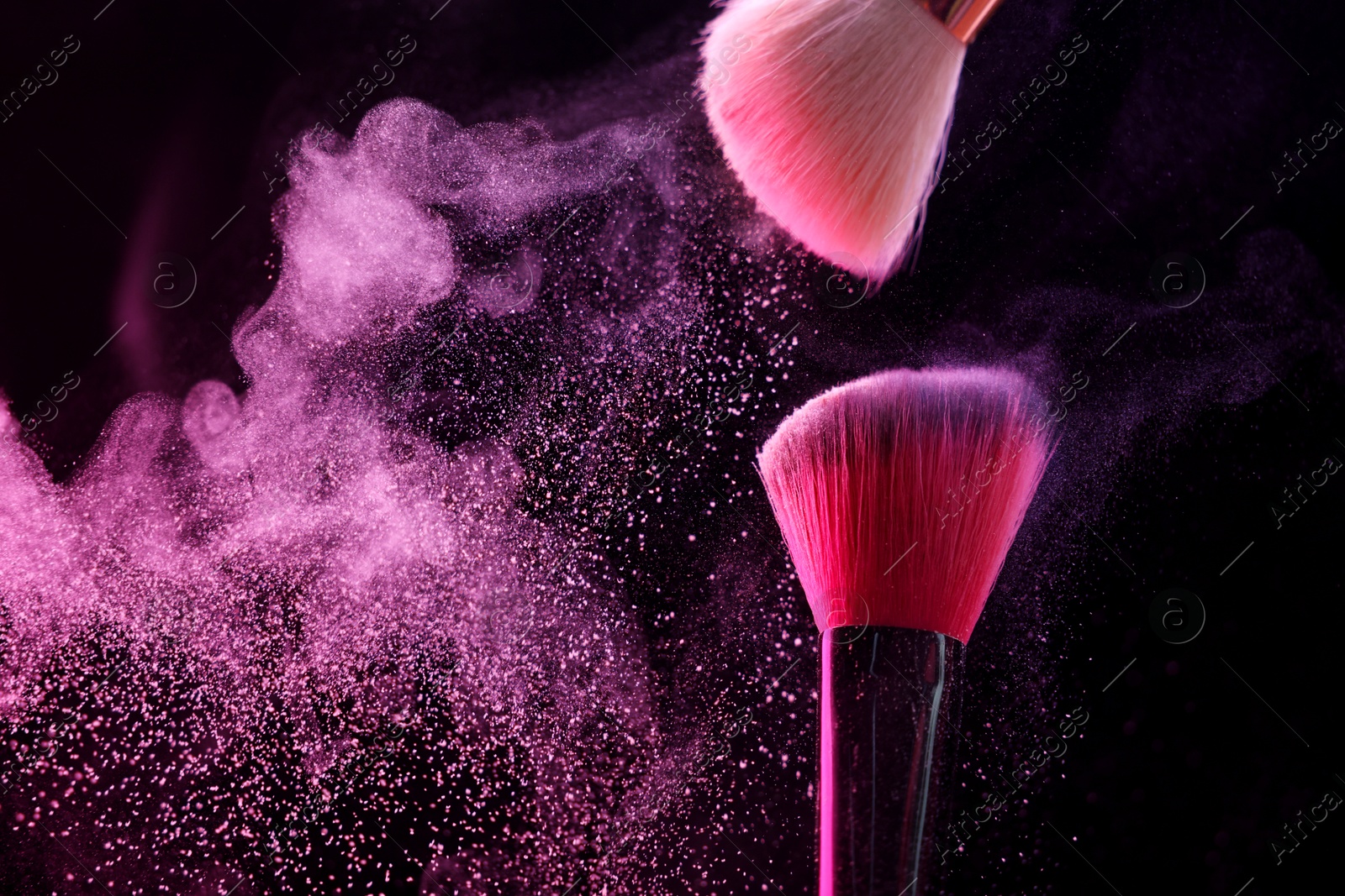 Makeup brushes with pink eye shadow on black background, closeup. Space for text Photo of Makeup brushes with pink eye shadow on black background, closeup. Space for text