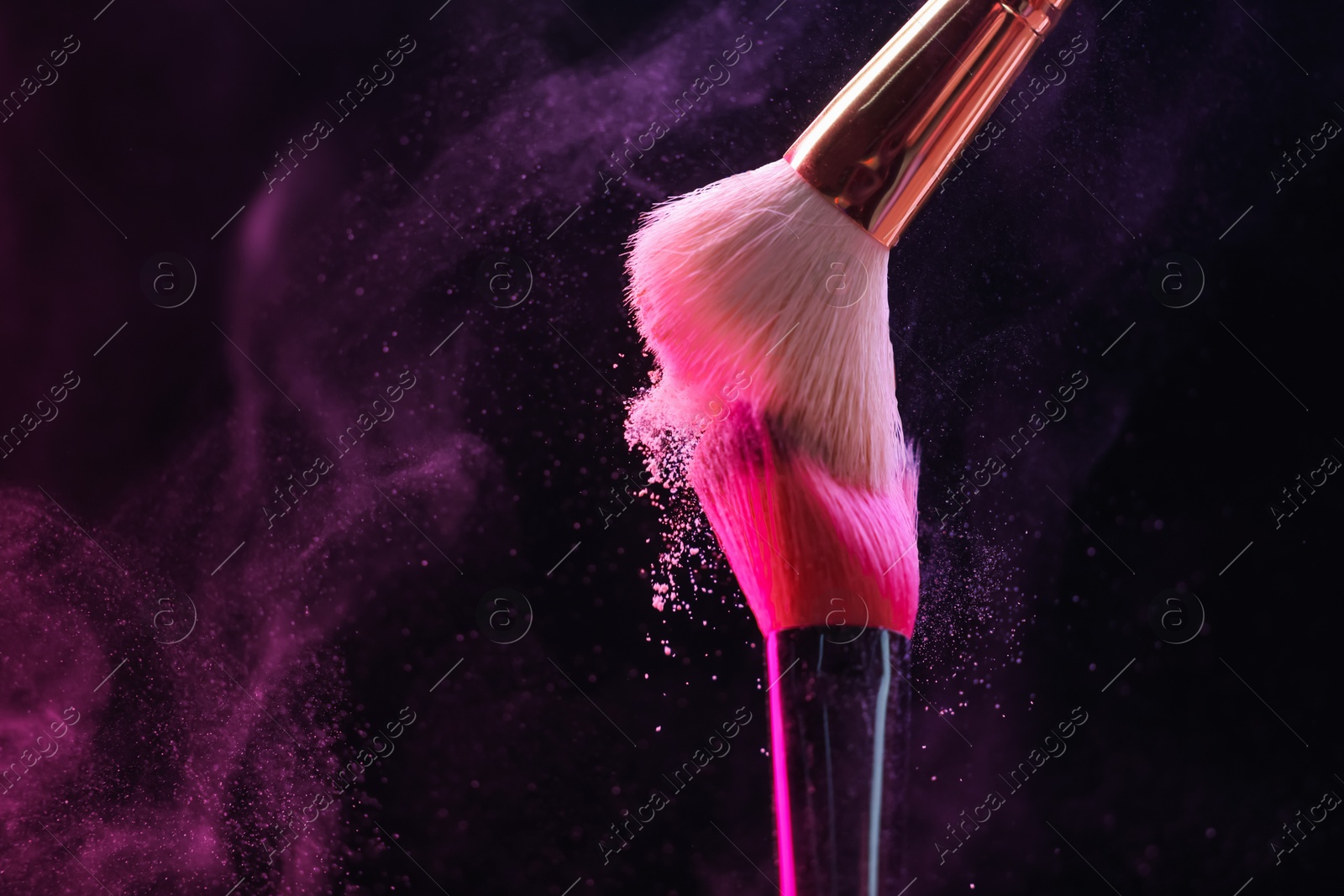Photo of Makeup brushes with color eye shadow on black background, closeup. Space for text